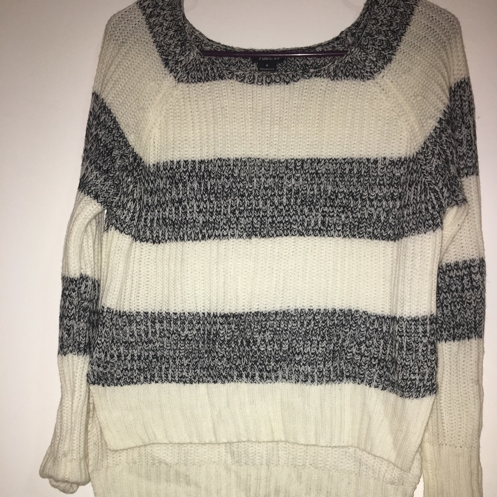 a white and grey sweater